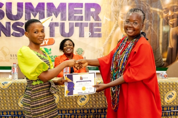 Mentor presents a leadership certificate to a smiling young achiever, marking her outstanding contributions.