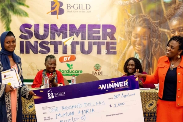 Mumuni Horia receives the B-GILD Gold Prize with a $1,000 cheque for her excellence and impact in the 12–15 age category.