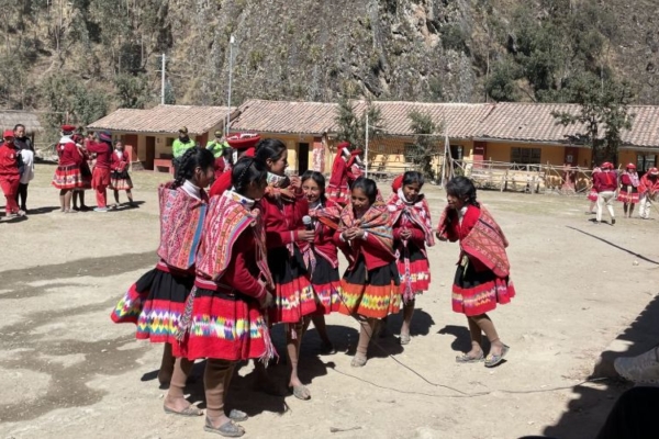 Locals in their cultural clothes performing a ritual in Peru.
