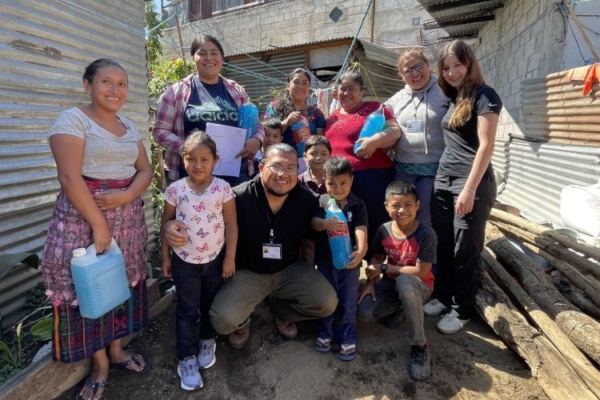 A group photo consisting of a family and interns.