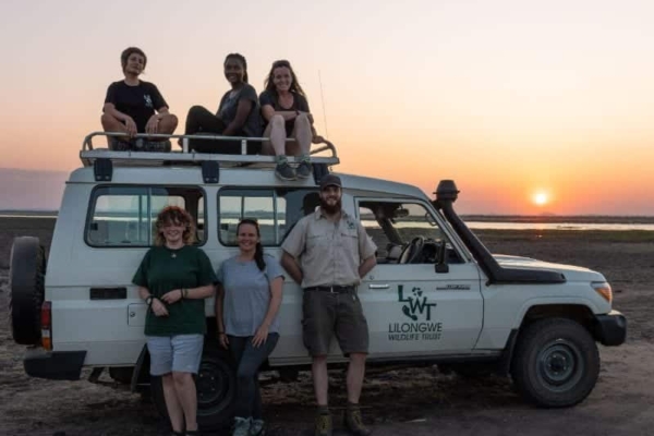 Interns enjoy the sunset in the Liwonde National park after doing some research on the wildlife.