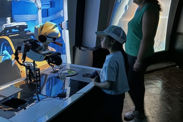 A kid amazed at the robot display created in Ecuador through the Robotics Internship.