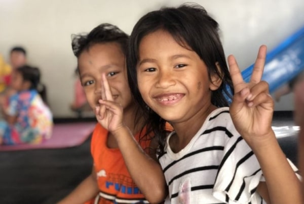 Two children posing for a picture in Cambodia.