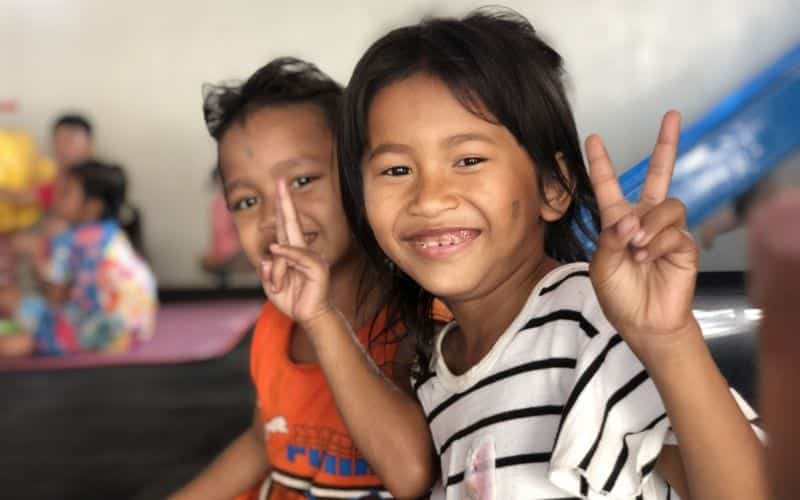 Two children posing for a picture in Cambodia.