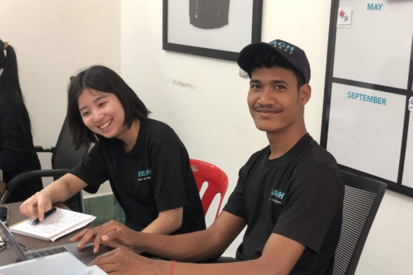 Two interns posing for a picture while creating programs for the Public Health Internship in Cambodia.