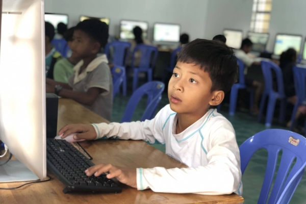A child using a computer in Cambodia.