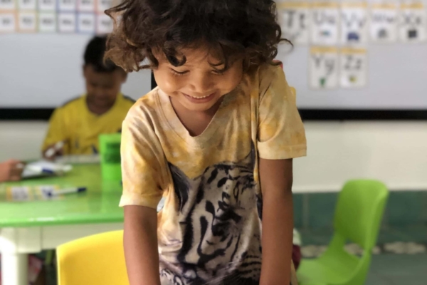 A child enjoying a work book created by the interns of the public health internship in Cambodia.
