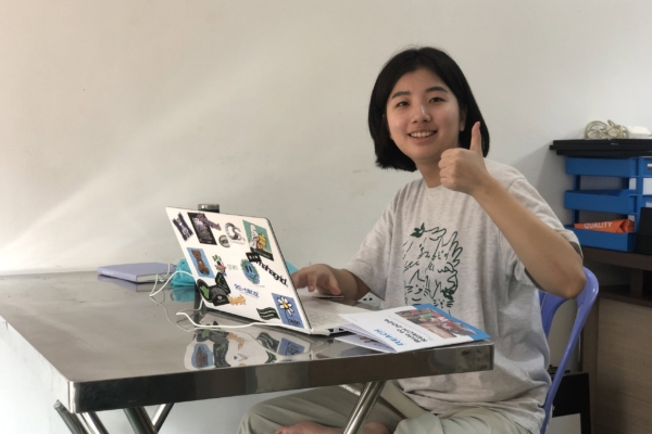An intern for the Public Health Internship in Cambodia on her laptop.