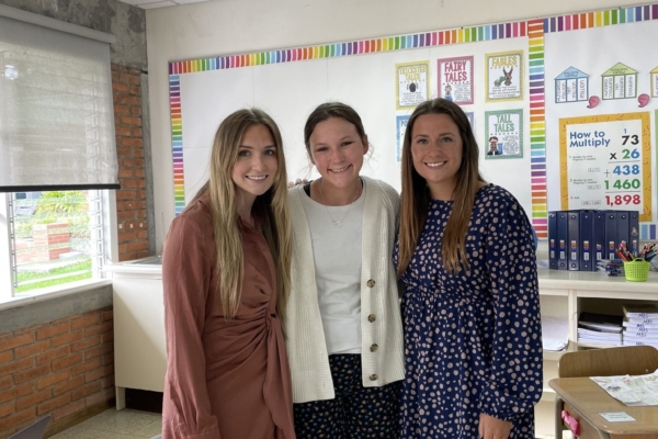 Interns posing for a picture in a classroom.