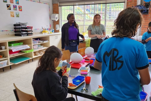 A group of interns helping the kids with their arts and crafts.