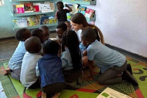 An intern sharing some stories with the children in Malawi.