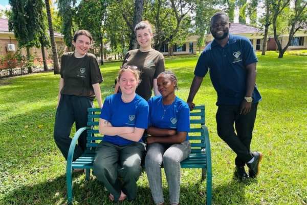 Five Law & Human Rights interns posing for a picture on a bench in Malawi.