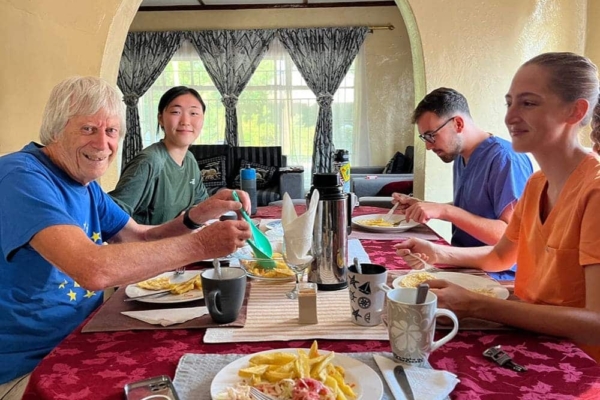 Interns gathered around a table to share a meal together.