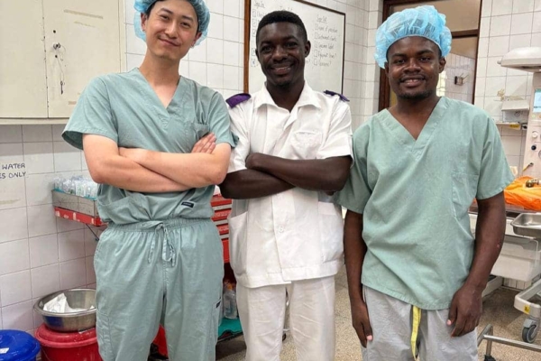Medical interns in Malawi posing for a picture inside a clinic.