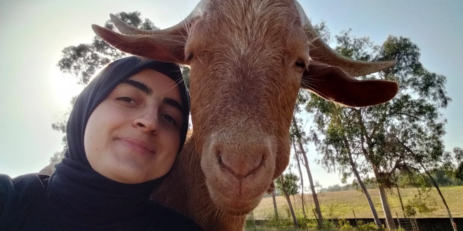 veterinary intern in Portugal taking a selfie with a goat