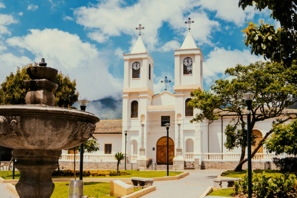 a church in Quito, Ecuador, with a fountain in front of it