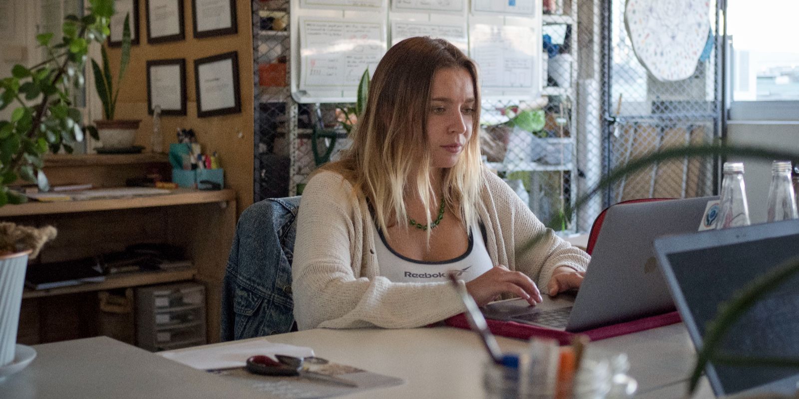 a woman working on a laptop in an office