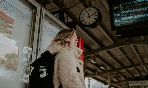 a woman waiting at a train station