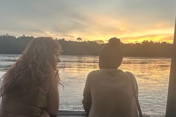 Two women looking out over a body of water.