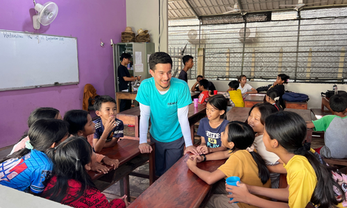 Gavi standing in a group of students.