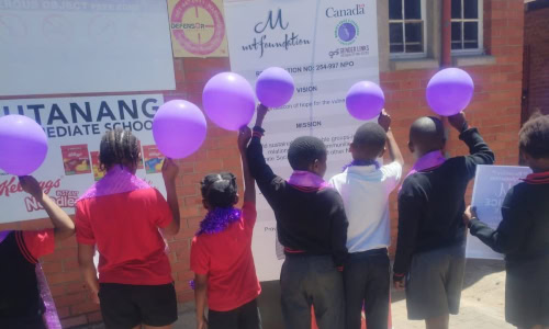 kids holding purple balloons